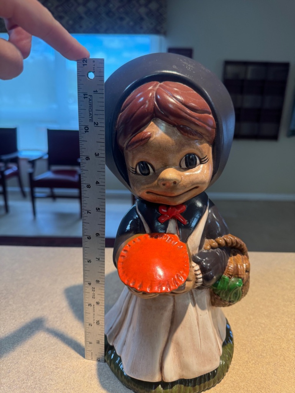 Hand-painted ceramic figurine titled 'Pilgrim Girl with Pie'